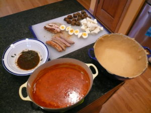 Some of the ingredients from our Timpano recipe: Ragu, crust, Italian sausage, soft-boiled eggs, chicken, meatballs, mozzarella cheese